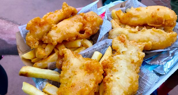 Crispy fish and hearty fries in themed baskets at Disney World—grab your meal and get cast member sauce tips for extra magic!.