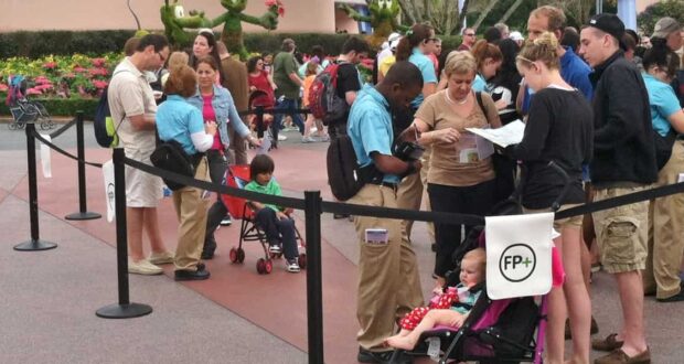 Guests form a queue at Disney World as helpful Cast Members assist and families keep kids in strollers, ensuring a magical visit.