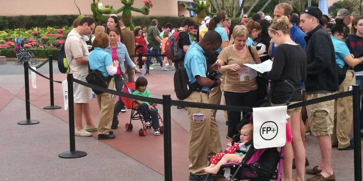 Guests form a queue at Disney World as helpful Cast Members assist and families keep kids in strollers, ensuring a magical visit.