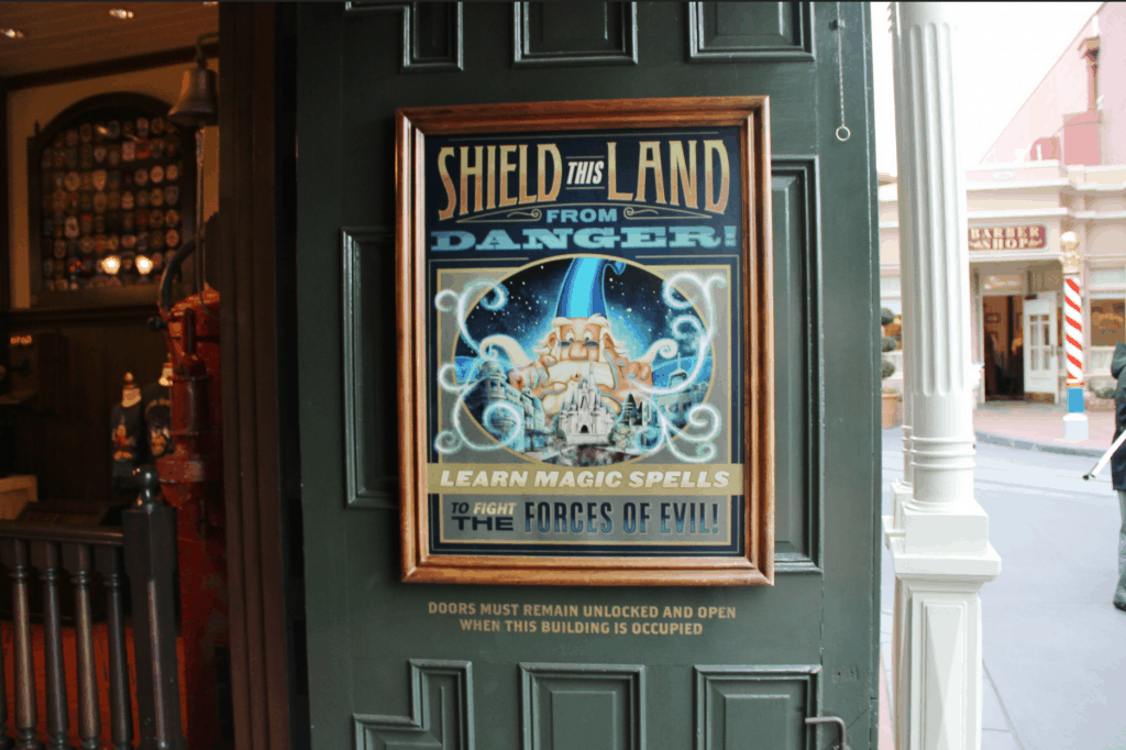 Poster on a door exclaims: “Protect this land! Kids can do hands-on activities and learn spells—just like Walt Disney World!”.