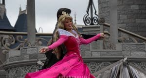 Sleeping Beauty twirls in her iconic pink gown on stage before the castle, enchanting Disneyland guests with a magical performance.