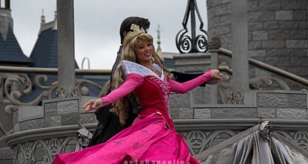 Sleeping Beauty twirls in her iconic pink gown on stage before the castle, enchanting Disneyland guests with a magical performance.