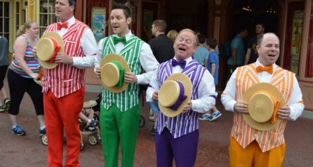 The Dapper Dans perform on Main Street, U.S.A., singing in colorful striped vests and holding straw hats at Disneyland.