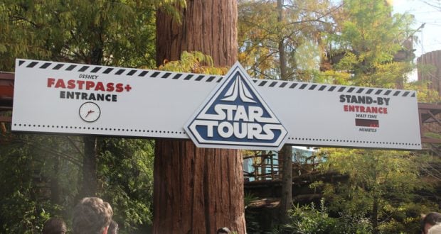 Star Tours – The Adventures Continue entrance with FastPass+ and Stand-By lanes, bustling guests, and lush greenery at Disney's Hollywood Studios.