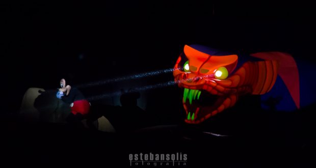 A glowing red and orange serpent with green fangs looms in the dark, capturing the pulse-pounding thrills of Hollywood Studios.