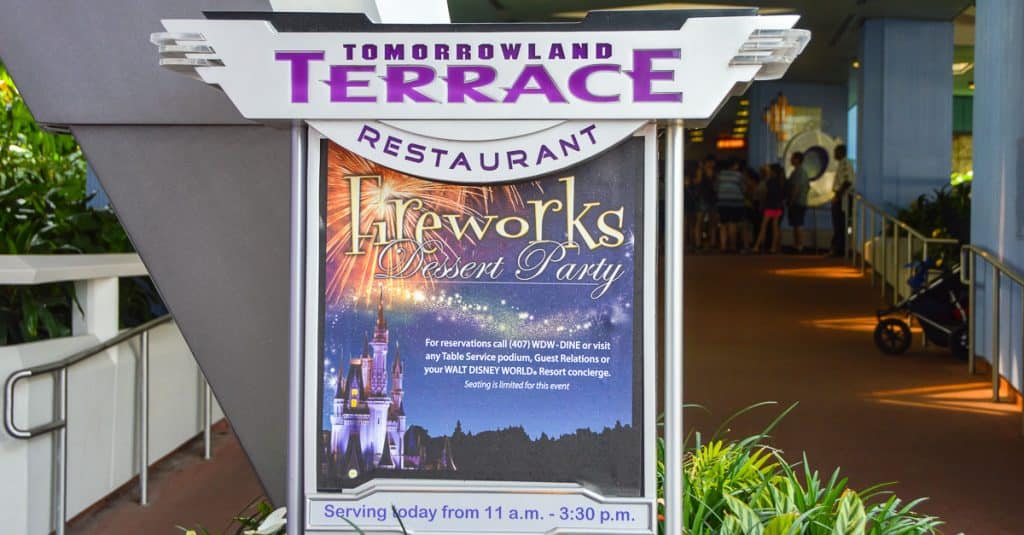 Tomorrowland Terrace sign promoting the Fireworks Dessert Party—an unforgettable Disney World must-do for park fans and couples.