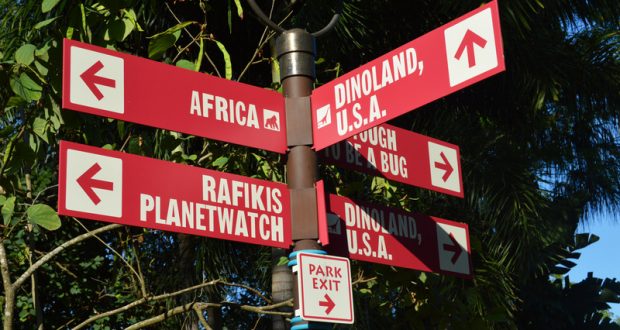Red signs at Disney's Animal Kingdom direct guests to Africa, Rafiki’s Planet Watch, and Dinoland U.S.A. for seamless park fun.