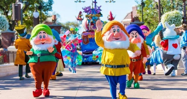 Dwarfs in vibrant costumes wave from a lively parade, infusing the park with Disney World’s signature festive excitement.