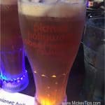 Planet Hollywood Observatory’s signature glowing drink, chilled with condensation, awaits on your Disney Springs adventure table.