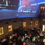 Planet Hollywood Observatory buzzing with guests, sports memorabilia, and giant video screens for an epic Disney Springs dining vibe.