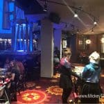 Guests enjoying a lively meal amid movie memorabilia and vibrant lighting at Planet Hollywood Observatory, the ultimate film fan dining.