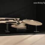 The Starship Enterprise model from Star Trek on display with clear stands, just like at Planet Hollywood in Disney World.