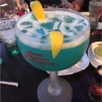 Planet Hollywood’s signature blue cocktail with ice and lemon, ready to enjoy at your Walt Disney World dining adventure.
