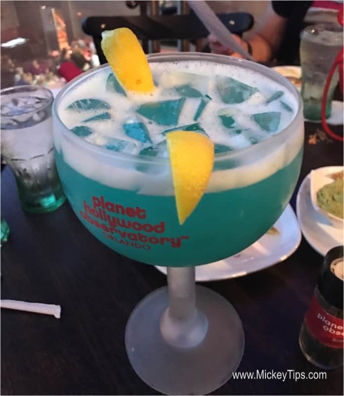 Planet Hollywood’s signature blue cocktail with ice and lemon, ready to enjoy at your Walt Disney World dining adventure.