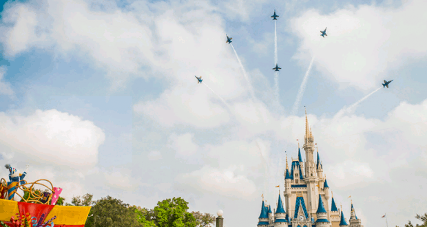 Blue Angels soar in tight formation over Cinderella Castle at Walt Disney World, dazzling guests during a vibrant daytime parade.