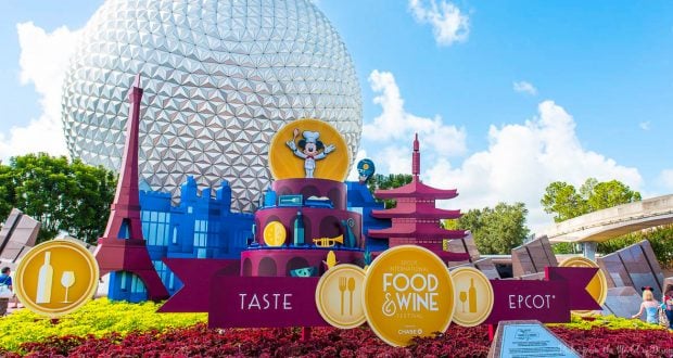 Mickey Mouse welcomes guests at Epcot’s vibrant Food & Wine Festival, set before the iconic Spaceship Earth geodesic dome.