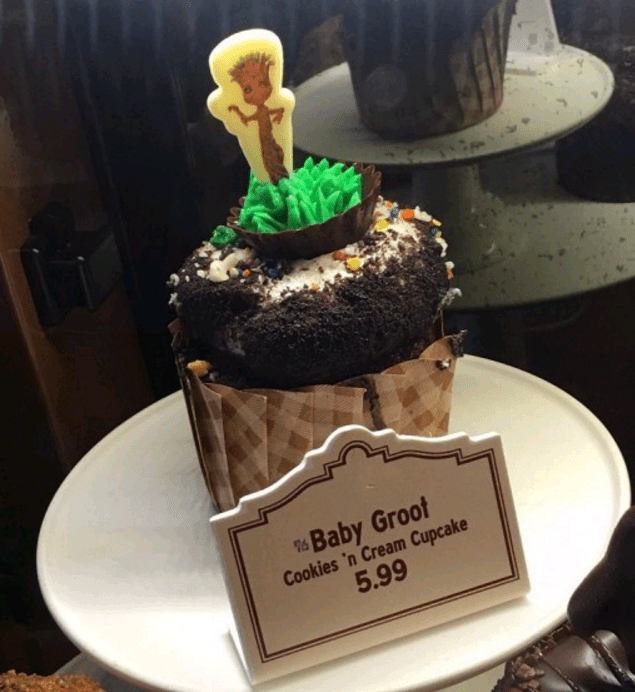 Baby Groot cookies and cream cupcake at Disney World, served on a white plate beside a price sign—an irresistible park treat.