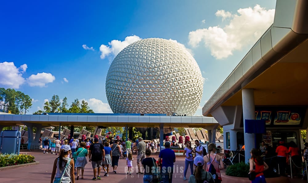 Guests stream toward Spaceship Earth at Epcot, soaking up sunny skies and lively park vibes on a perfect Disney World day.
