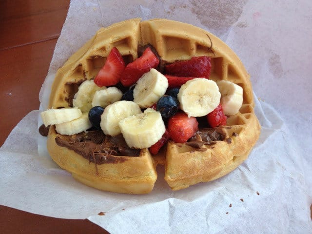 A Mickey-shaped waffle with bananas, strawberries, blueberries, and chocolate spread—just like a Disney Parks breakfast treat.