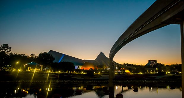 Epcot’s Spaceship Earth and monorail glow at sunset, their reflections shimmering on World Showcase Lagoon—a Disney must-see.