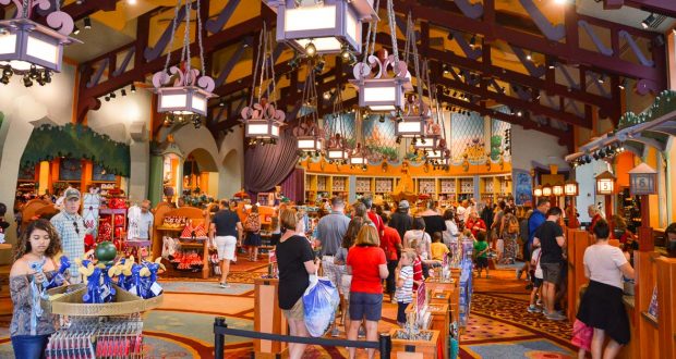 Guests browse for Disney-themed merchandise beneath soaring wooden beams in a vibrant gift shop at Walt Disney World.