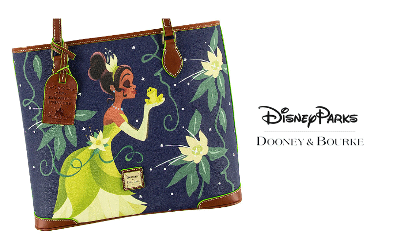 Disney Parks Dooney & Bourke navy tote with Princess Tiana, frog, florals, brown leather trim—an exclusive park style essential.
