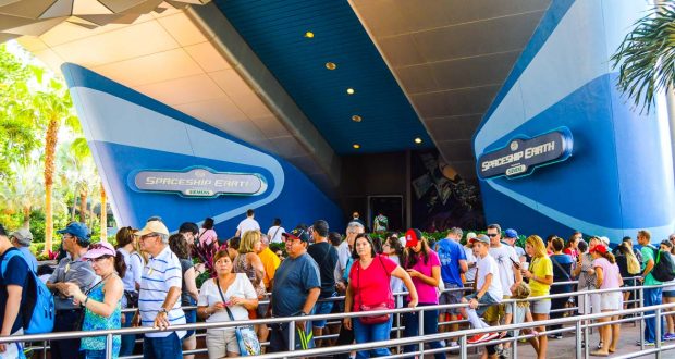 Disney fans line up at Epcot’s Spaceship Earth, gathering under iconic blue walls and signage for their Walt Disney World adventure.