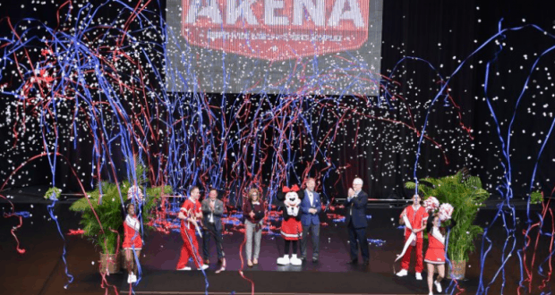 Fans cheer onstage as confetti and streamers fly under the glowing "The Arena" sign at ESPN Wide World of Sports Complex.