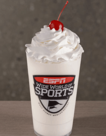 Vanilla milkshake with whipped cream and a cherry in an ESPN Wide World of Sports cup at Walt Disney World.