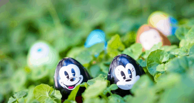 Cartoon-faced plastic eggs nestled in Epcot’s lush gardens, with colorful eggs celebrating Egg-Stravaganza at Walt Disney World.