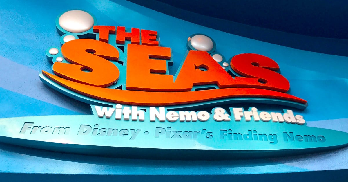 Vibrant “The Seas with Nemo & Friends” sign pops against a blue backdrop, welcoming guests to this kid-friendly EPCOT adventure.