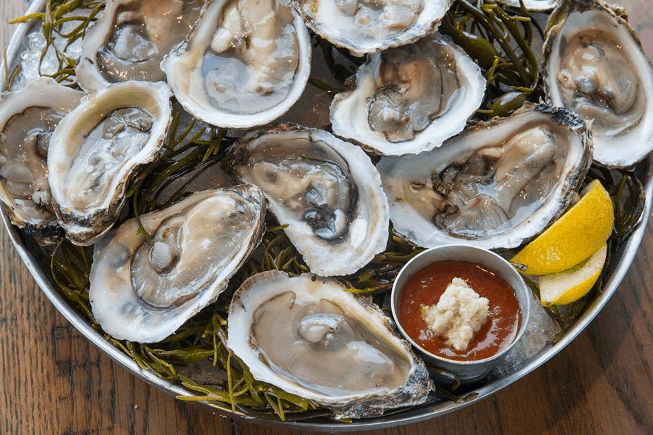 Celebrate your 1st Anniversary at Paddlefish, Walt Disney World with fresh oysters on seaweed, lemon wedges, and cocktail sauce.