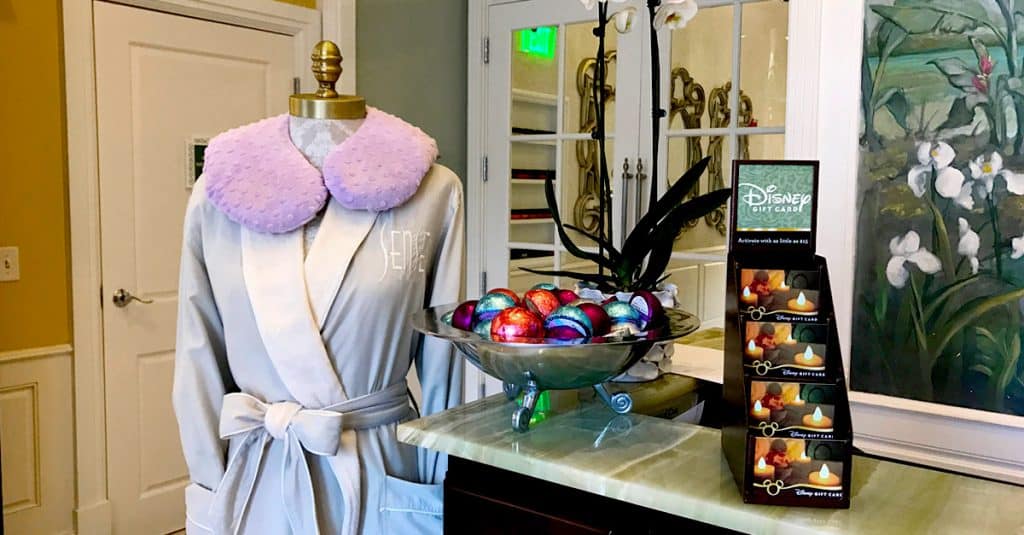A Disney World robe, festive candy eggs, and a Disney gift card invite fans to splurge on magical park souvenirs at the counter.