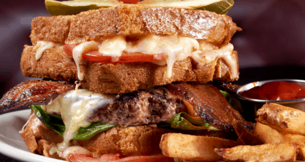 Edison’s Burger of the Month stars with sizzling cheese and bacon, served alongside fries and ketchup for a blockbuster meal.