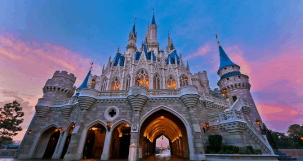 Cinderella Castle glowing at sunset with vibrant skies—catch this iconic Disney World view or stream it live on DisneyParksLIVE.
