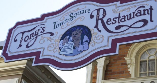 Tony’s Town Square Restaurant sign at Magic Kingdom, with a smiling dog and menu, radiating classic Disney dining charm.