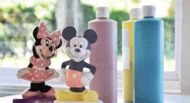 Mickey and Minnie Mouse figurines await a magical paint session with bright Disney-hued paints, recalling Disney World adventures.