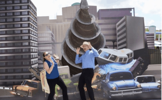 Guests strike playful poses with the oversized fake poop and crushed car at Tomorrowland Expo’s whimsical photo spot downtown.
