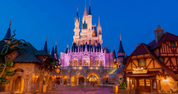 Cinderella Castle glows at dusk, surrounded by enchanting village buildings, creating the ultimate Disney World event backdrop.