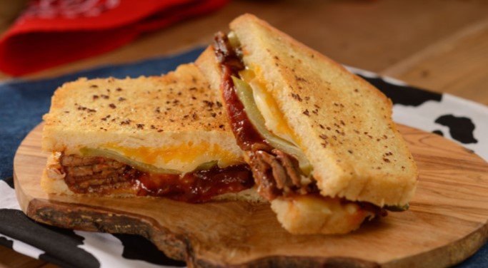 Barbecue meat and melted cheese sandwich with pickles, just like at Woody’s Lunch Box in Disney’s Hollywood Studios.