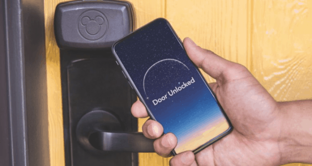 Unlocking magic at Disney Resorts: a phone with "Door Unlocked" held by a Mickey lock, highlighting the Digital Key feature.