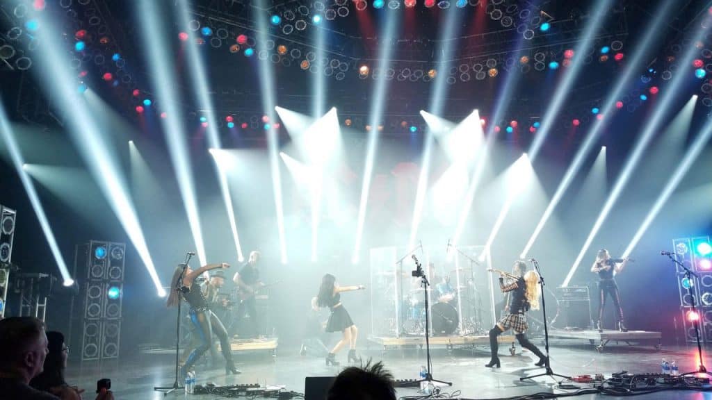 A rock band rocks the stage under dazzling lights at the 2018 Epcot Food & Wine Festival in Walt Disney World.