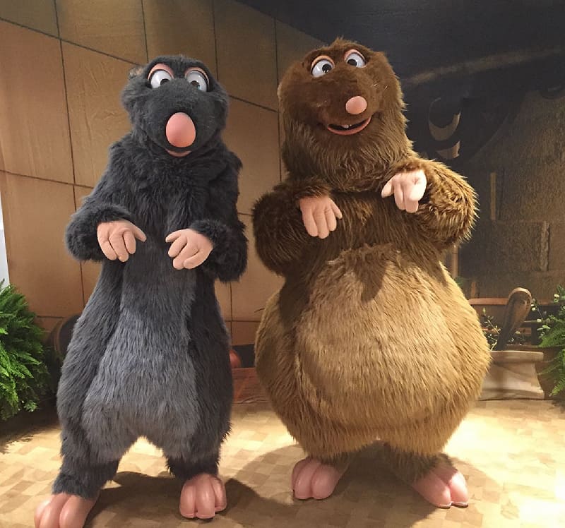 Remy and Emile greet guests on a patterned floor at the 2018 Epcot Food & Wine Festival in Walt Disney World.