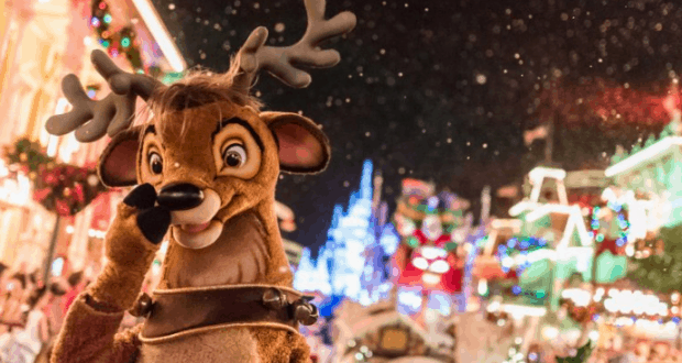 A reindeer character greets guests on a snow-dusted, twinkling Main Street during Mickey's Very Merry Christmas Party at Magic Kingdom.