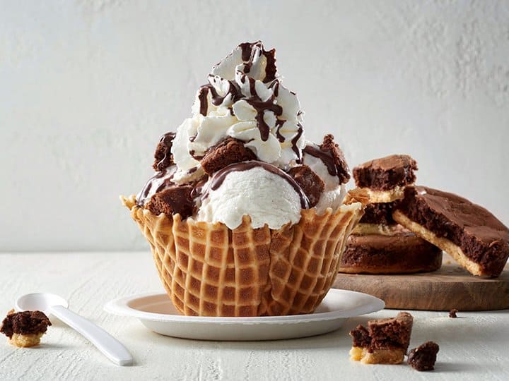 Decadent waffle bowl sundae with brownies, whipped cream, and chocolate sauce—a Disney Springs must-try for chocoholics.