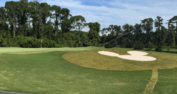 On the golf course green, a Mickey Mouse-shaped bunker mirrors the whimsy of Walt Disney World’s signature design.