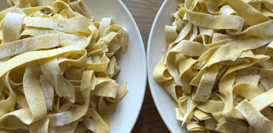 Uncooked homemade fettuccine in two bowls from Terralina Crafted Italian, ready to bring Disney Springs flavors home.