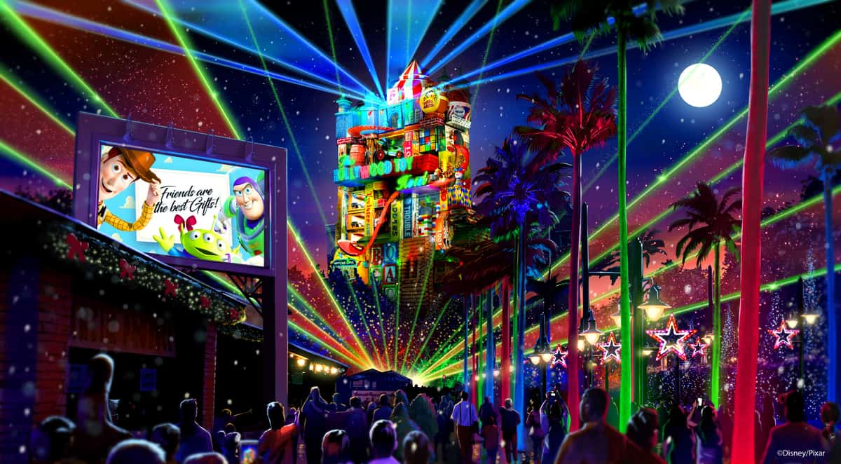 Laser lights dazzle Hollywood Studios guests at night by Tower of Terror, with a Toy Story billboard shining in the background.