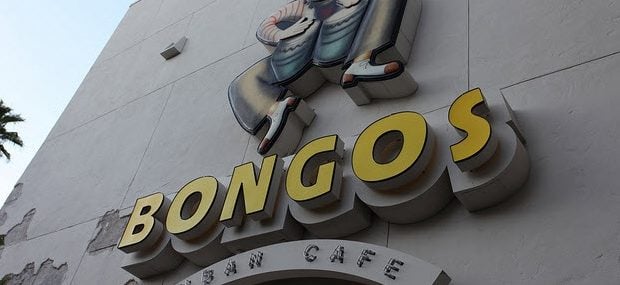 BONGOS" sign and playful drummer cartoon atop the building, capturing the festive spirit of Bongos Cuban Café at Disney Springs.