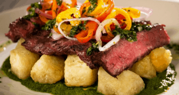 Steak and fried gnocchi with cherry tomatoes, onions, and herbs on green sauce at Sebastian’s Bistro, Disney World.